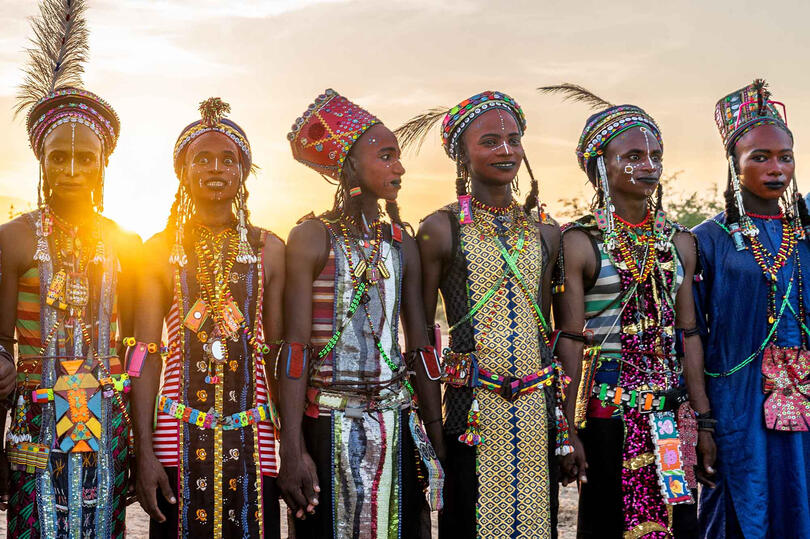 Sunset on Gerewol Sudosukai - Wodaabe people celebrating the Gerewol festival at sunset Buy Print