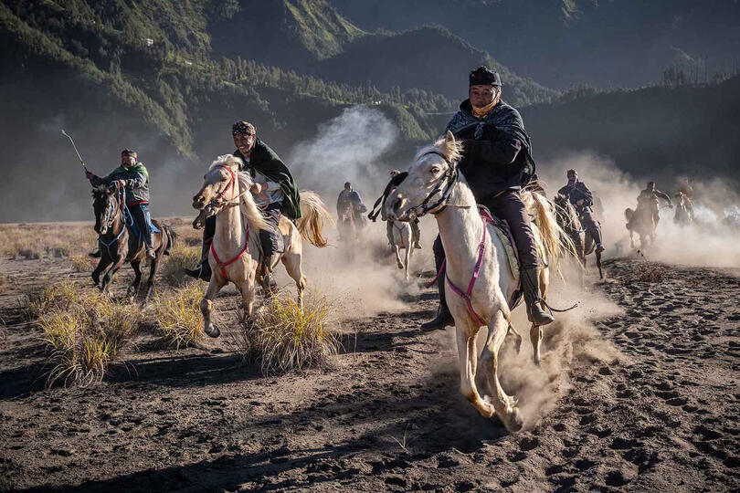 The Ride A group of Tengger horsemen riding at the foot of the Bromo volcano Buy Print