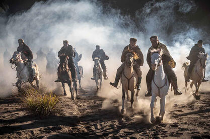 Spirits in the Dust A group of Tengger horsemen riding at the foot of the Bromo volcano Buy Print