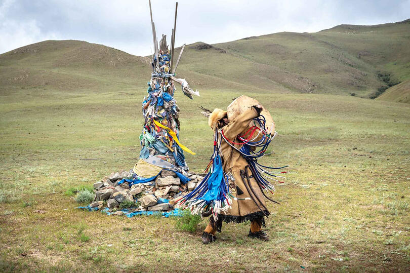 Talking with the Ancestors Portrait of a shaman entering a trance beside a sacred cairn, known as ovoo © Roberto Pazzi