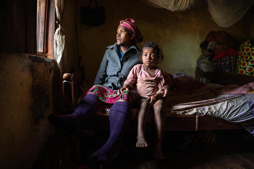 Mother and Daughter An intimate family portrait of a mother and daughter in their humble home Buy Print