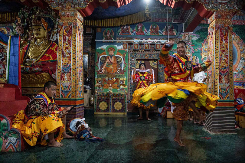 Before the Dance Dancers of the Tshechu warming up before their performance © Roberto Pazzi