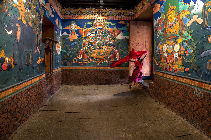 Run into the Light Young Buddhist monk entering a Dzong Buy Print