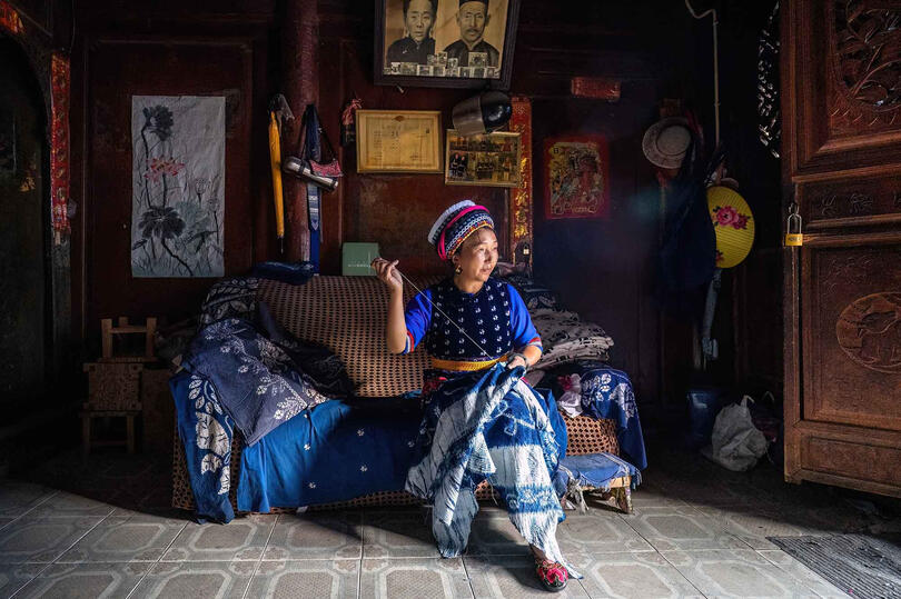 Bai Woman Portrait of a Bai woman working on the traditional batik craft © Roberto Pazzi