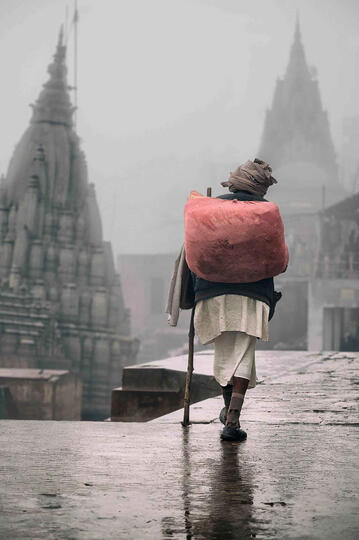 The Man of the Fog Street scene in a foggy Varanasi Buy Print
