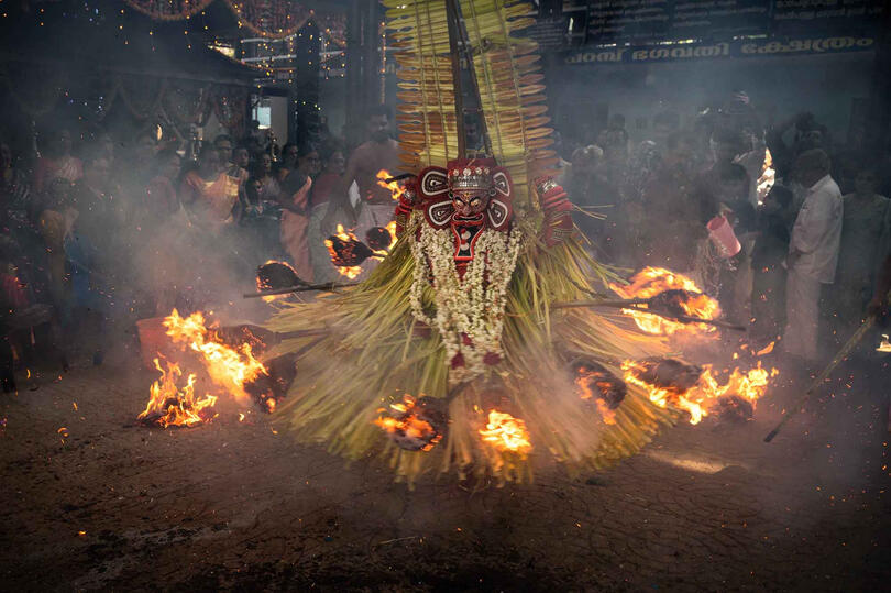 Dancing with the Fire A moment of the Hindu shamanic ritualistic dance of Theyyam © Roberto Pazzi