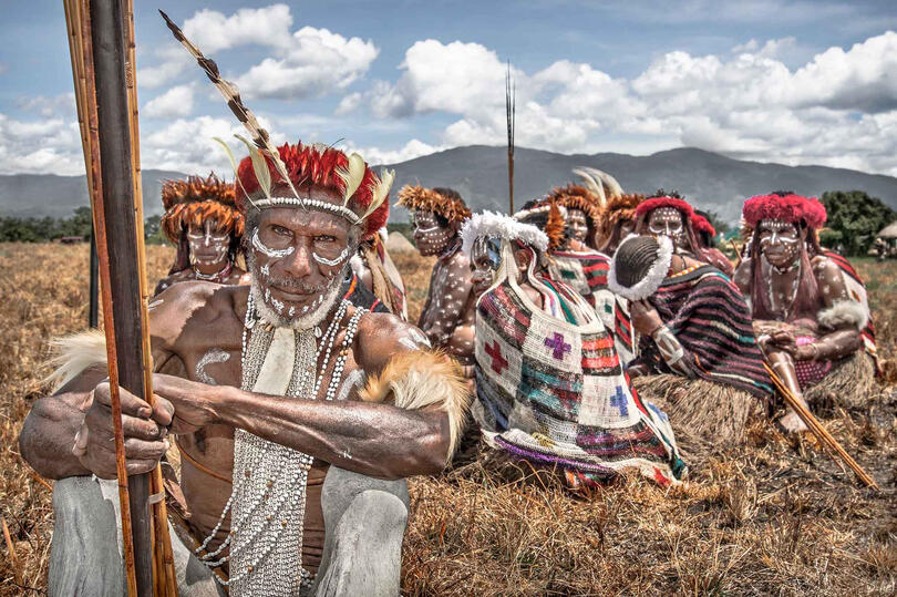 The Last Tribe Portrait of a Dani tribesman with his people © Roberto Pazzi
