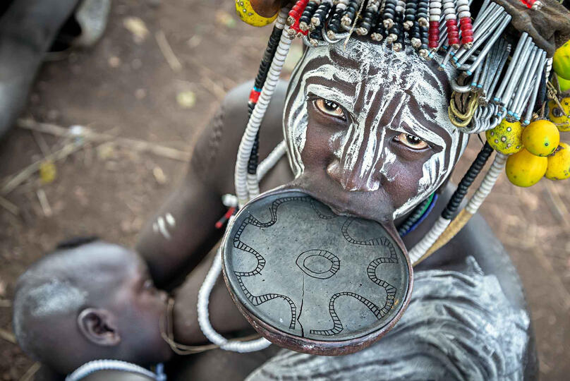 Mursi Mother Portrait of a young Mursi mother with her baby Buy Print