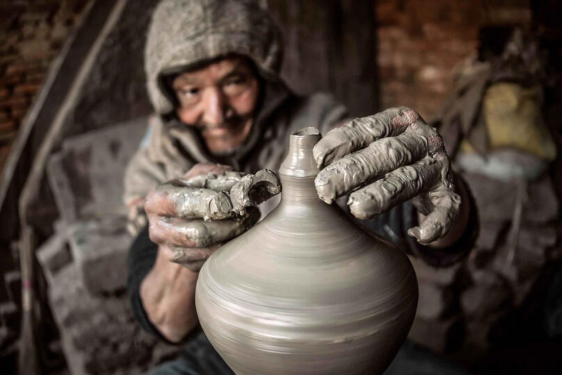 Work and Passion Portrait of an elderly potter at work in his workshop Buy Print