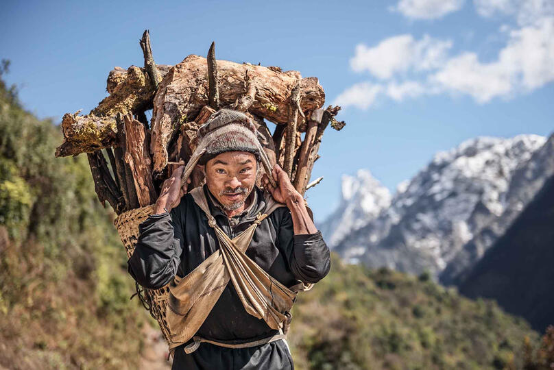 The Lumberjack Portrait of a man with a load of firewood © Roberto Pazzi