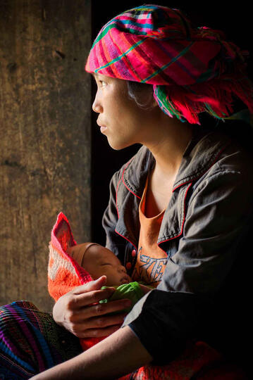 Strength and Tenderness Portrait of a young Hmong mother with her baby Buy Print
